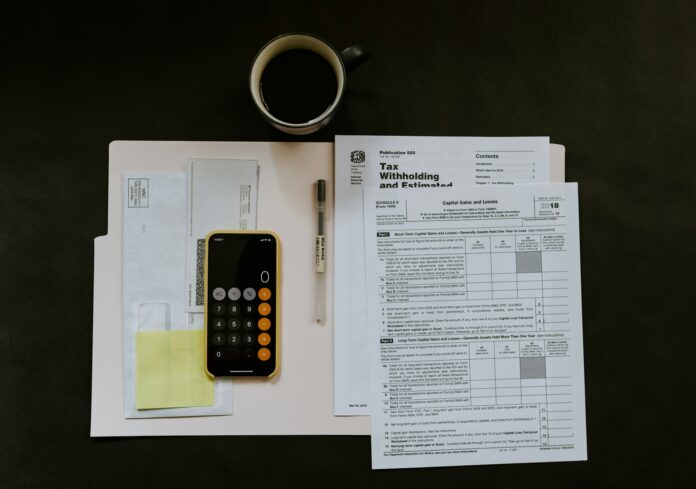 kelly-sikkema-M98NRBuzbpc-unsplash key documents and a calculator used by a fifa footbal agent
