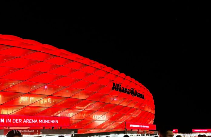 Allianz Arena illuminated in red at night in Munich, Germany.