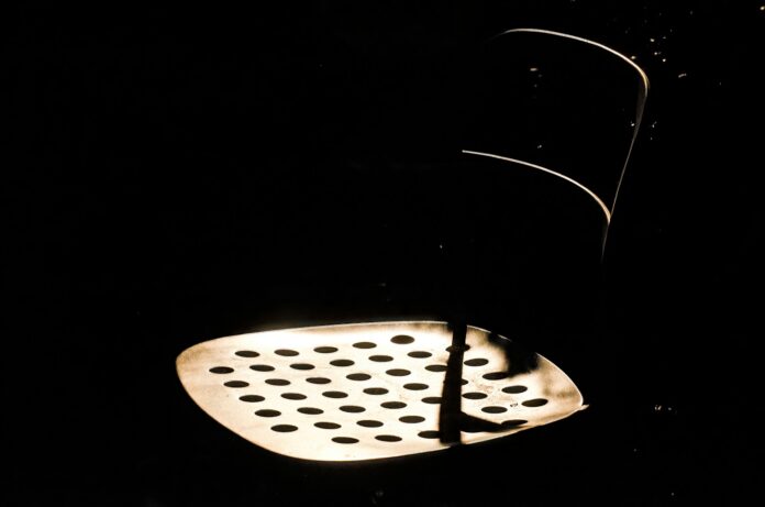 Empty chair under spotlight in dark room, symbolizing lost opportunities or public silence
