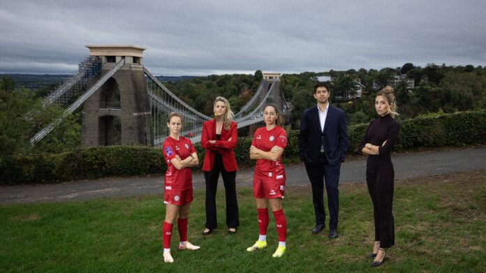 Emily Syme, Hannah Haynes, Vicky Losada, Mario Malavé, and Victoire Cogevina Reynal stand in front of the Clifton Suspension Bridge in Bristol, marking Mercury13’s acquisition of Bristol City Women.