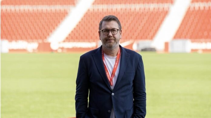 Martin Przondziono, football executive and former Bundesliga player, standing in a stadium during his career as a sports director and consultant.