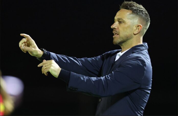 Paul Temple giving instructions from the touchline during a football match.