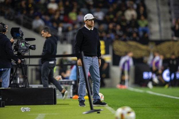 Ryan Martin, head coach of Loudoun United FC, standing on the touchline during a match.