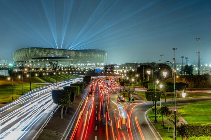 Prince Moulay Abdellah Stadium in Rabat illuminated at night with light beams, symbolizing Morocco’s modern football infrastructure and 2026 World Cup ambitions.