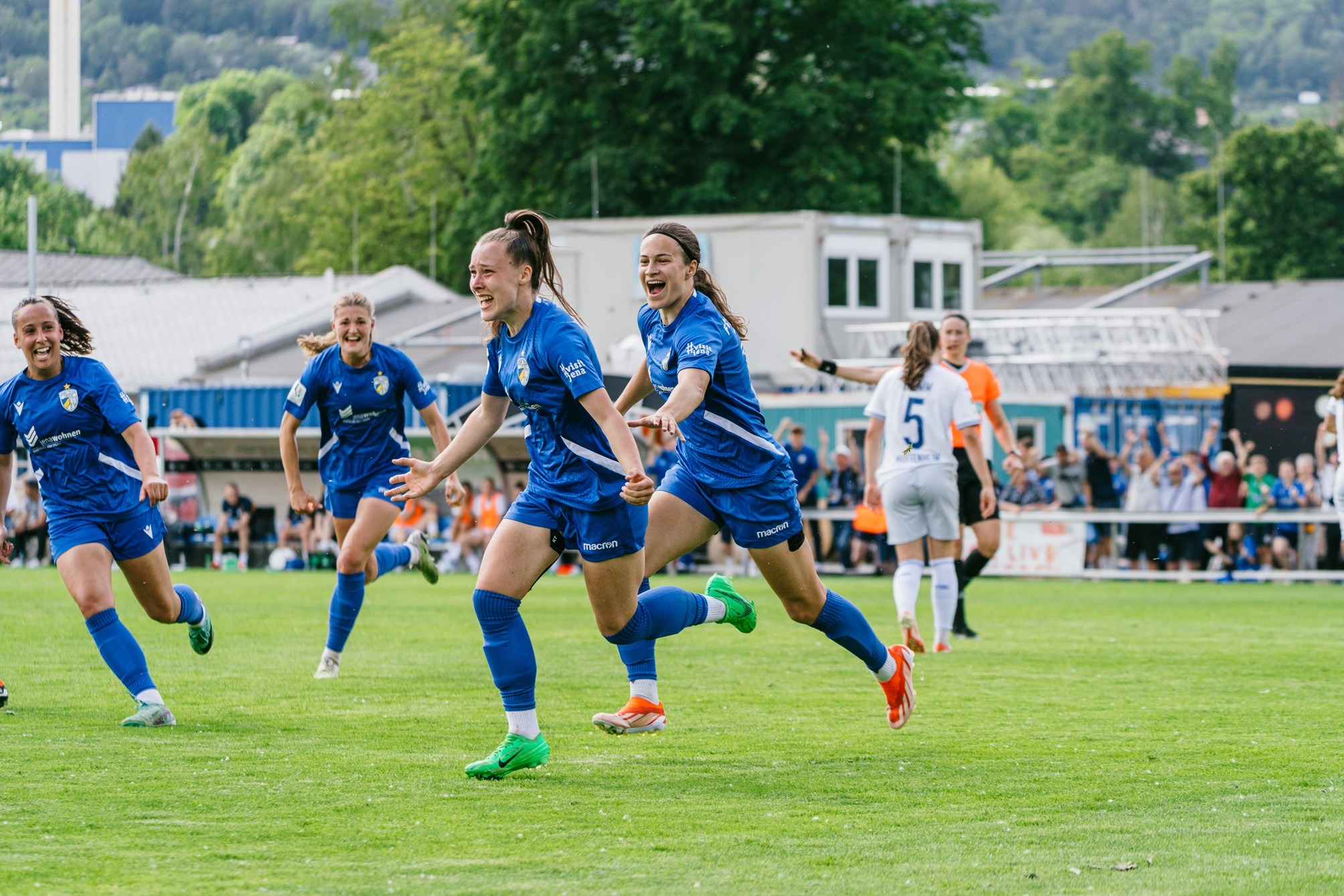 FC Carl Zeiss Jena players celebrate a decisive goal during their Bundesliga promotion match.