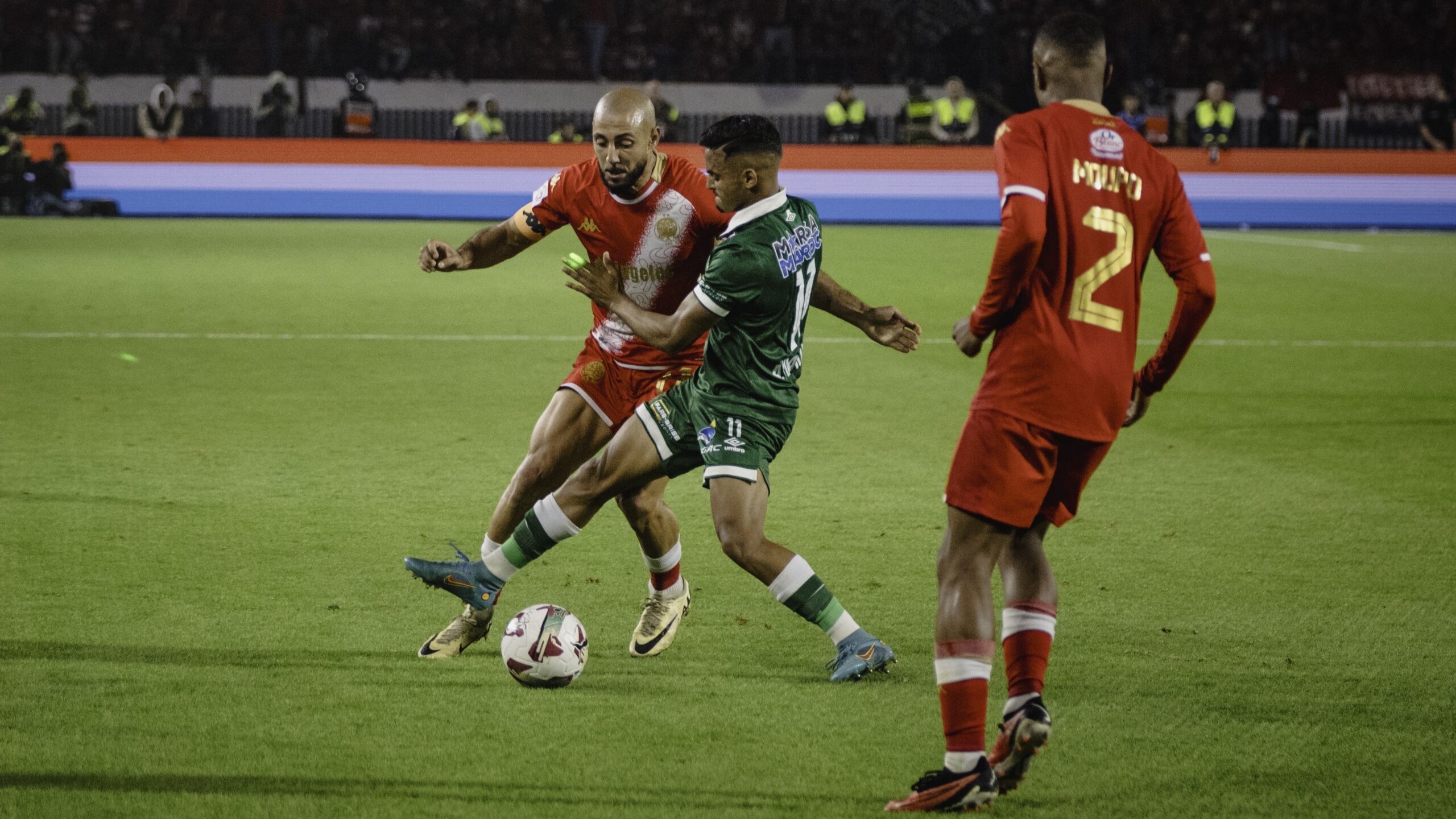 Wydad and Raja players in action during the Casablanca Derby at Mohammed V Stadium.