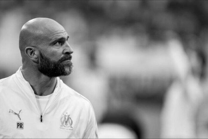 Paolo Rongoni 1 Paolo Rongoni observing the pitch with focus during his role as a top performance coach.