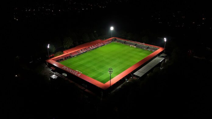 The Peninsula Stadium Aerial night view of The Peninsula Stadium in Salford, symbolizing the connection between football, business, and community value.