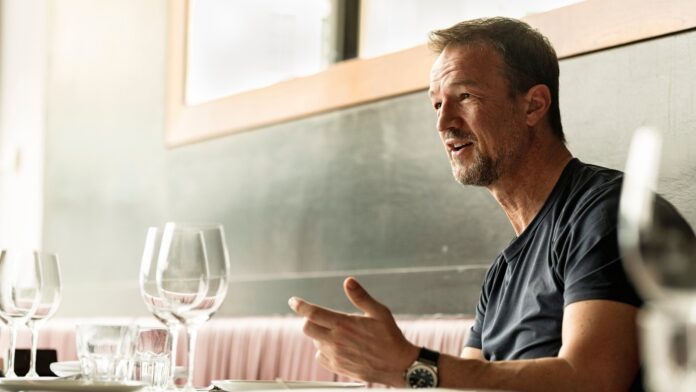 Fredi Bobic C Fredi Bobic speaking during an interview at a restaurant, reflecting on his football and executive career.