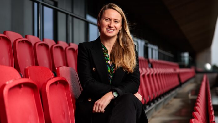 Lowri Roberts sits in the stands at Bristol City Women after being appointed Interim CEO under the new Mercury13 ownership.