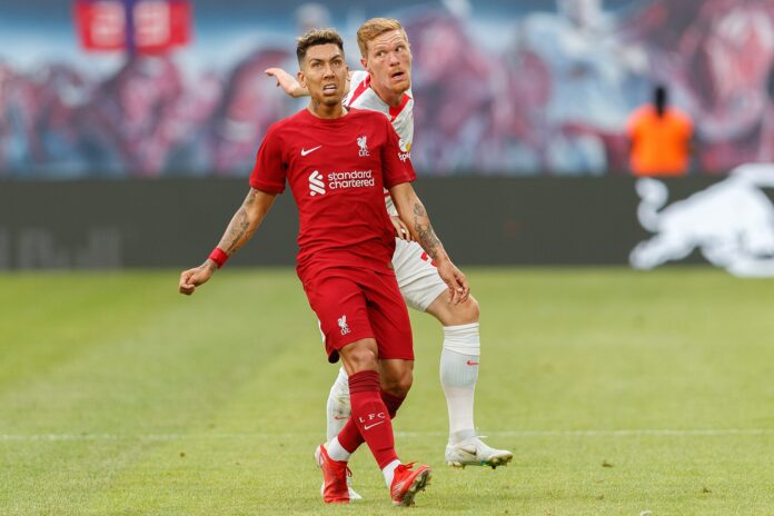 Roberto Firmino applying defensive pressure during open play, illustrating the modern defensive striker role.