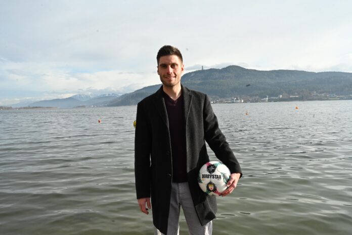 Marc Lamberger Marc Lamberger first team goalkeeper coach at SK Austria Klagenfurt holding a football by the lake