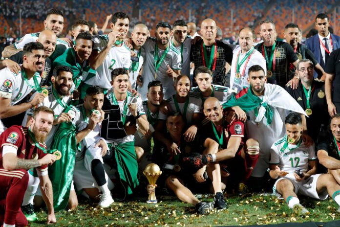 Amara Merouani Algeria national team celebrating Africa Cup of Nations victory with staff and players