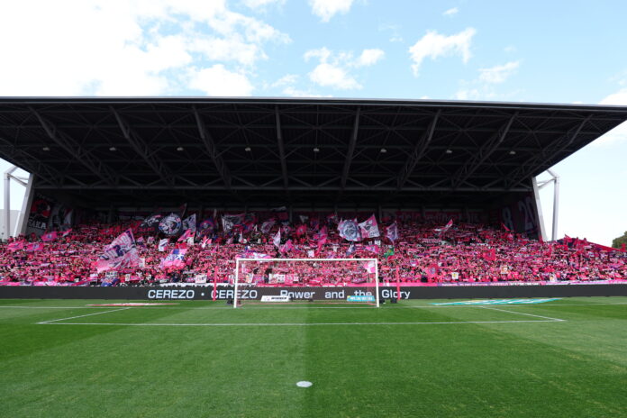 Cerezo Osaka supporters fill the stands with pink flags creating a vibrant fan culture atmosphere in the J League
