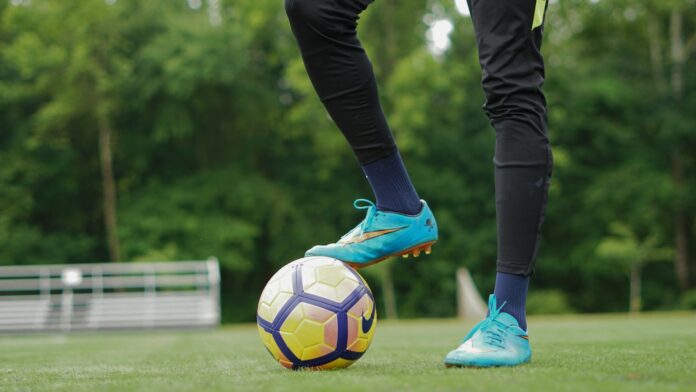 Footballer controlling the ball during training, symbolizing focus and mental performance in elite football.