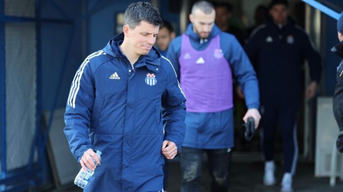 Stjepan Babić walks out with players before training, reflecting his leadership and hands-on coaching approach