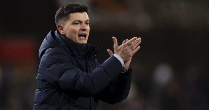 Ognjen Zarić coaching on the touchline, giving instructions during a professional football match