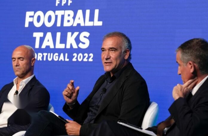 Paulo Noga speaking at a football leadership conference, discussing strategy and player development in elite environments