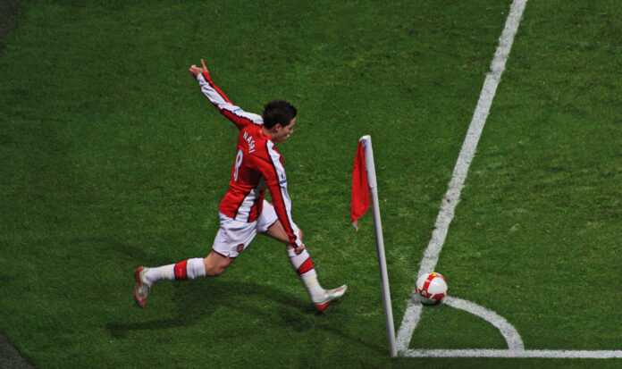 Samir Nasri takes a corner kick for Arsenal, highlighting the tactical importance of set pieces in modern football.