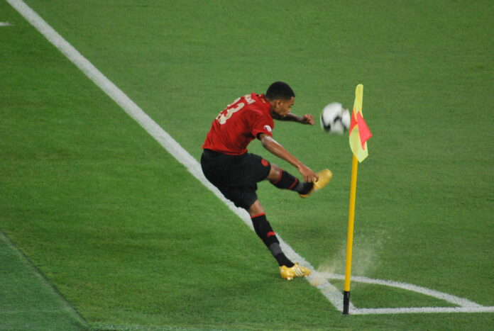 Player takes a corner during the 2009 Emir of Qatar Cup Final, highlighting set-piece strategy.
