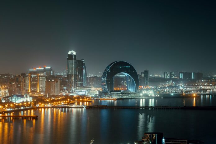 Baku skyline at night, highlighting the city’s rise as an emerging strategic hub in the football industry.