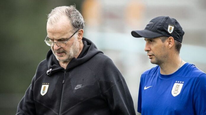 Enzo Ferrari works alongside Marcelo Bielsa during a Uruguay national team training session.