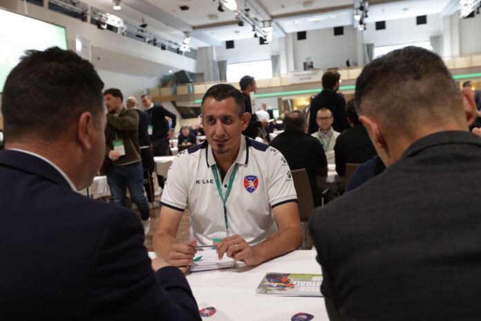 Albion FC executive in a football networking meeting focused on international club development.
