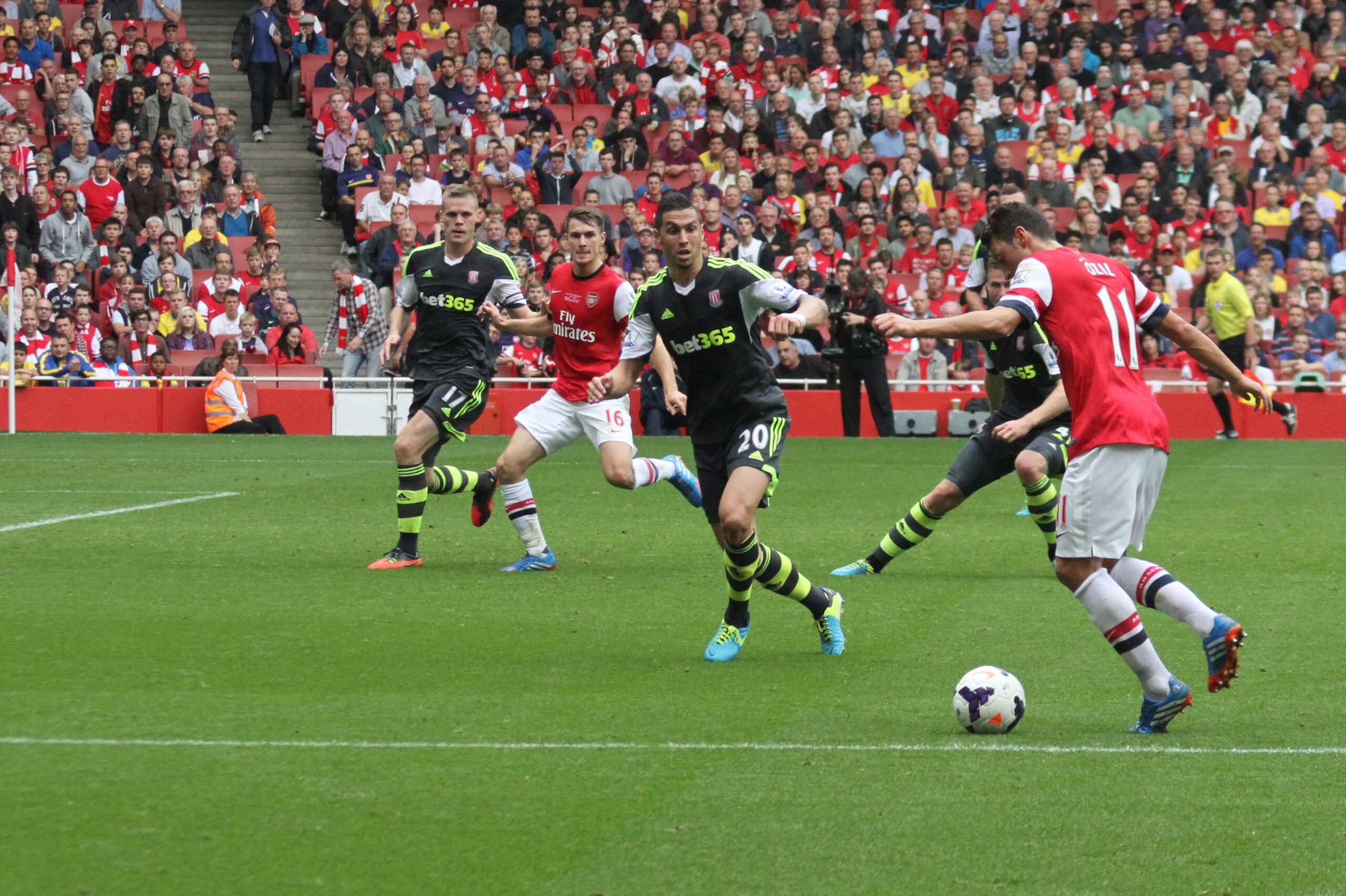 Mesut Özil playing for Arsenal against Stoke City, reflecting the vision and creativity of the classic number 10.