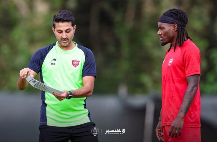 Mehrdad Khanban coaching a player during training, reflecting tactical analysis and elite football development.