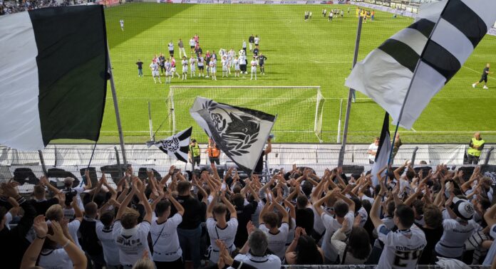 SV Elversberg supporters wave black-and-white flags during the club’s emotional Bundesliga rise.