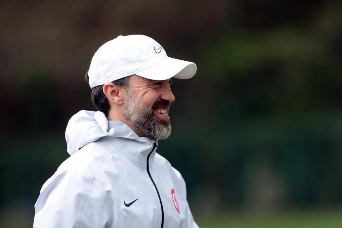 Uğur İnceman smiling at training, reflecting his leadership with the Turkish U19 national team.