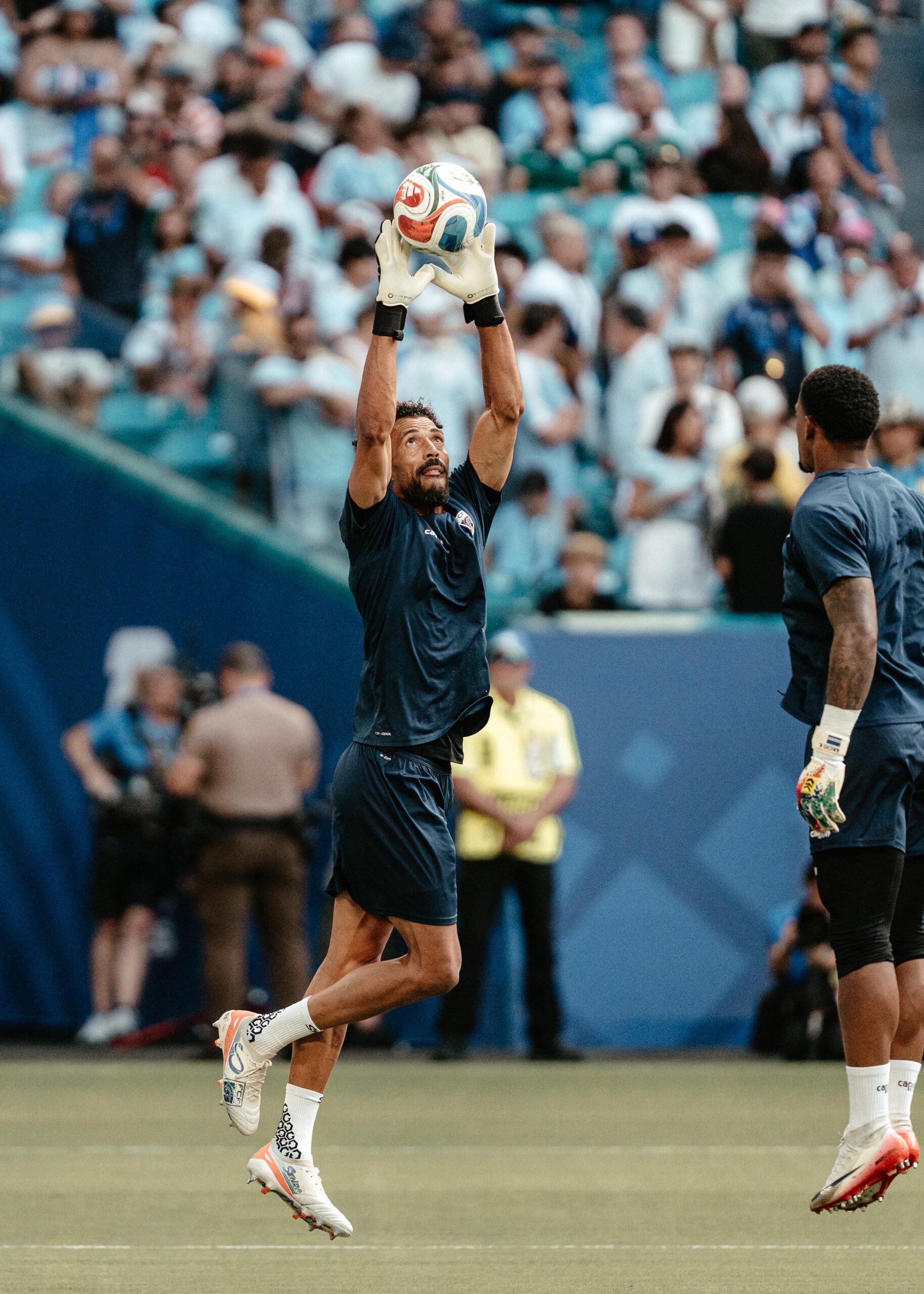 Vozinha catches the ball during World Cup training while wearing Senda boots.