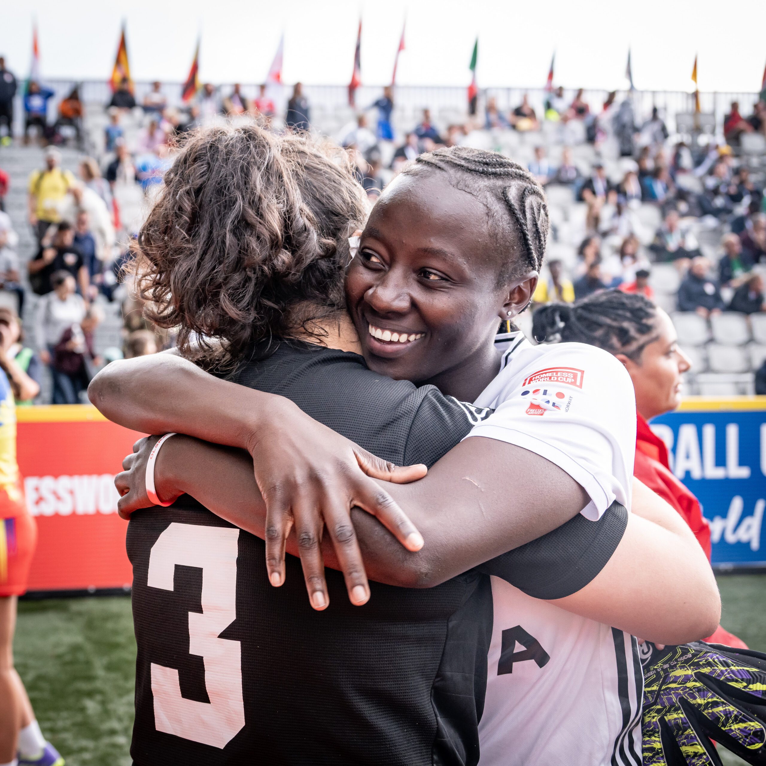 Players embrace after a Homeless World Cup match.