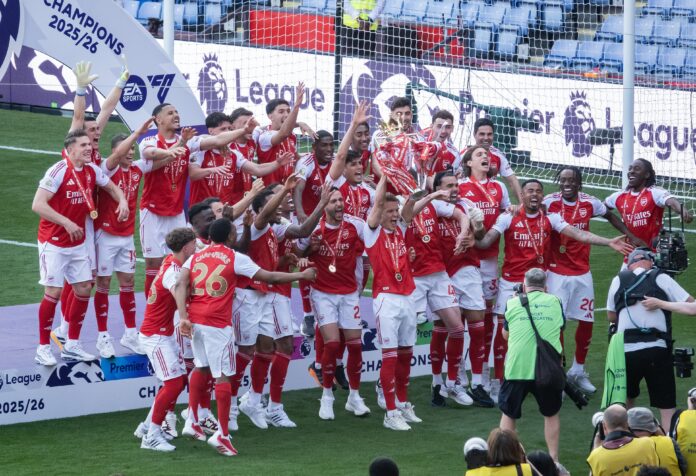 Arsenal players celebrate lifting the Premier League trophy after winning the title