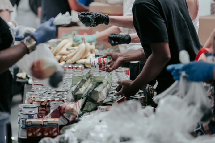 Volunteers organise food donations for a community charity project