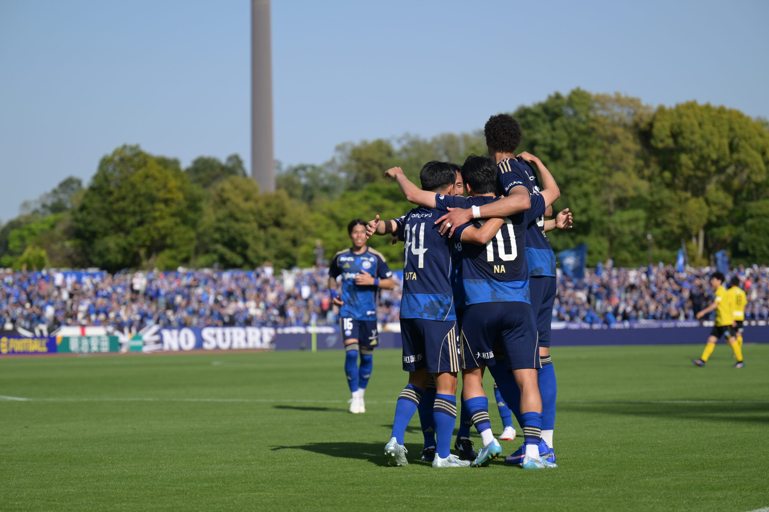 FC Machida Zelvia players celebrate together during a J.League match