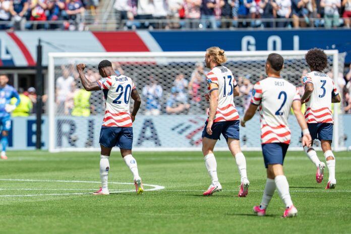Folarin Balogun celebrates for the United States during an international football match