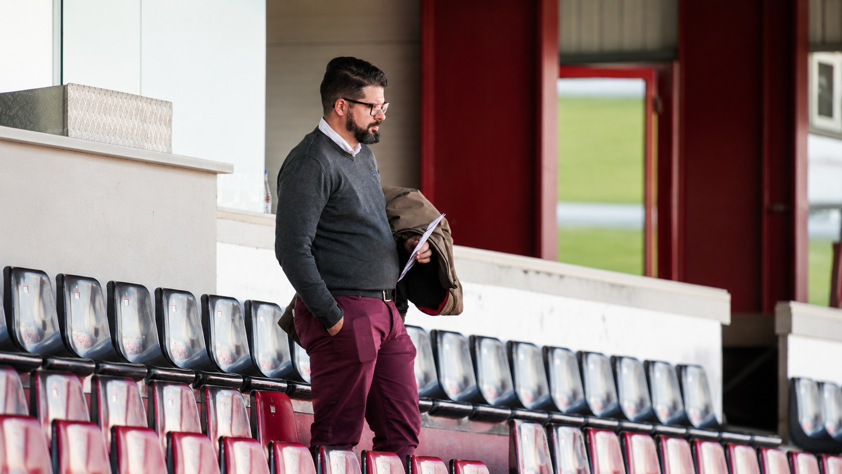 José Manuel Hernández observing from the stands during a football scouting environment