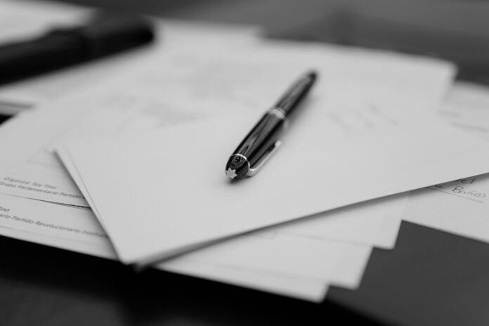 Contract documents and pen representing football transfer legal risks