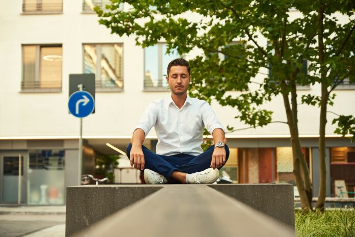 Football agent meditating outdoors, reflecting calm leadership and emotional intelligence in player representation.