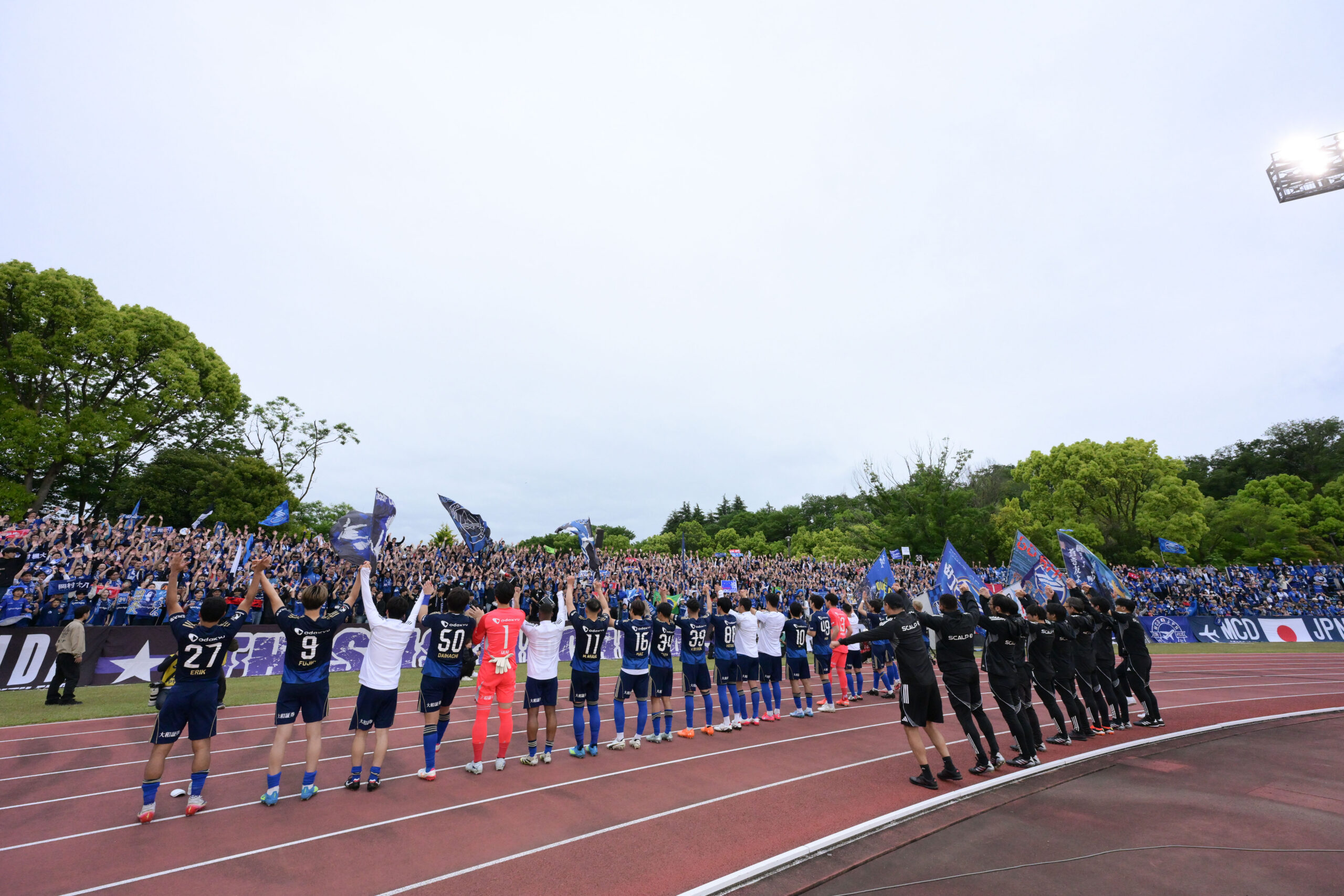 FC Machida Zelvia players salute supporters after a J.League match