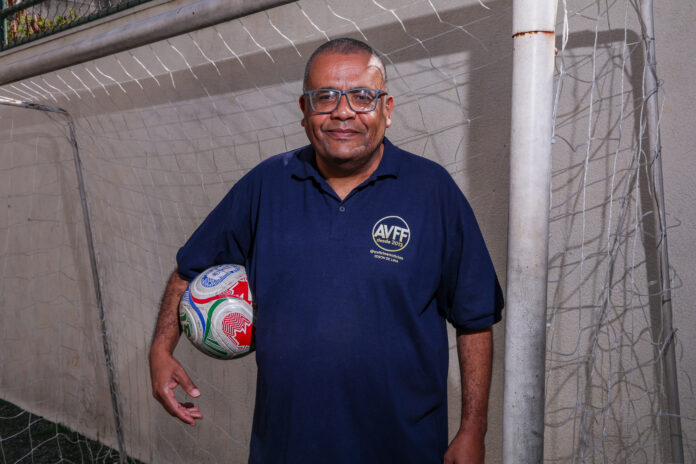 Edson de Lima with a football, reflecting his work documenting and preserving the history of Brazilian women’s football.