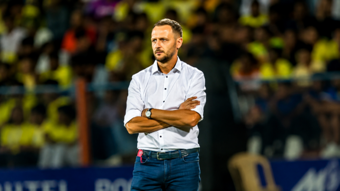 Ivan Vukomanović coaches from the touchline during a competitive football match.