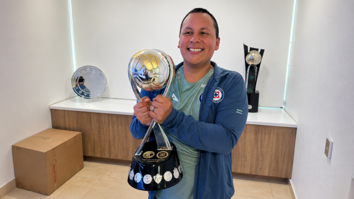 Romel Alejandro Hernández Reséndiz holding a trophy while wearing Cruz Azul training apparel.