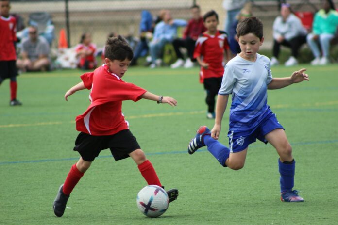 Young soccer players compete for the ball, representing the development pathway behind MLS Homegrown Players.