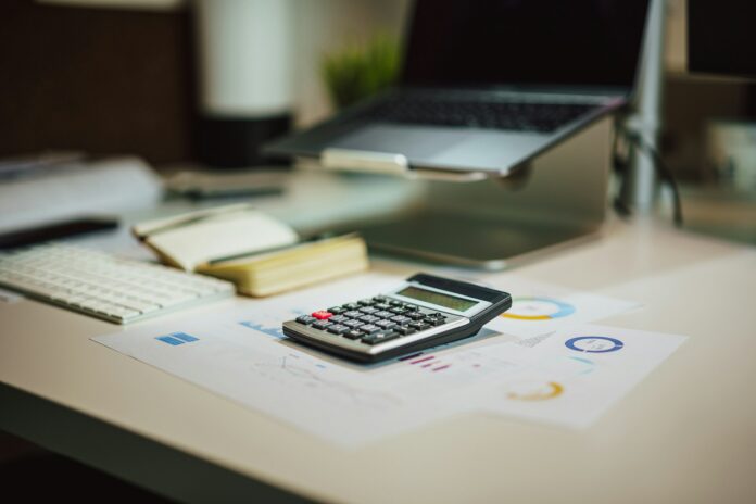 Calculator on financial reports representing MLS salary budget calculations and player contract buyouts.