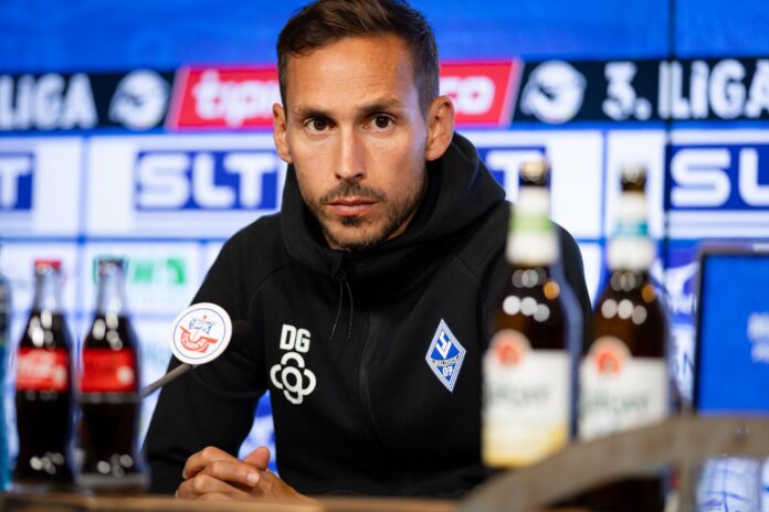 Waldhof Mannheim coach Dominik Glawogger speaks at a post-match press conference in Rostock on 10 August 2025.