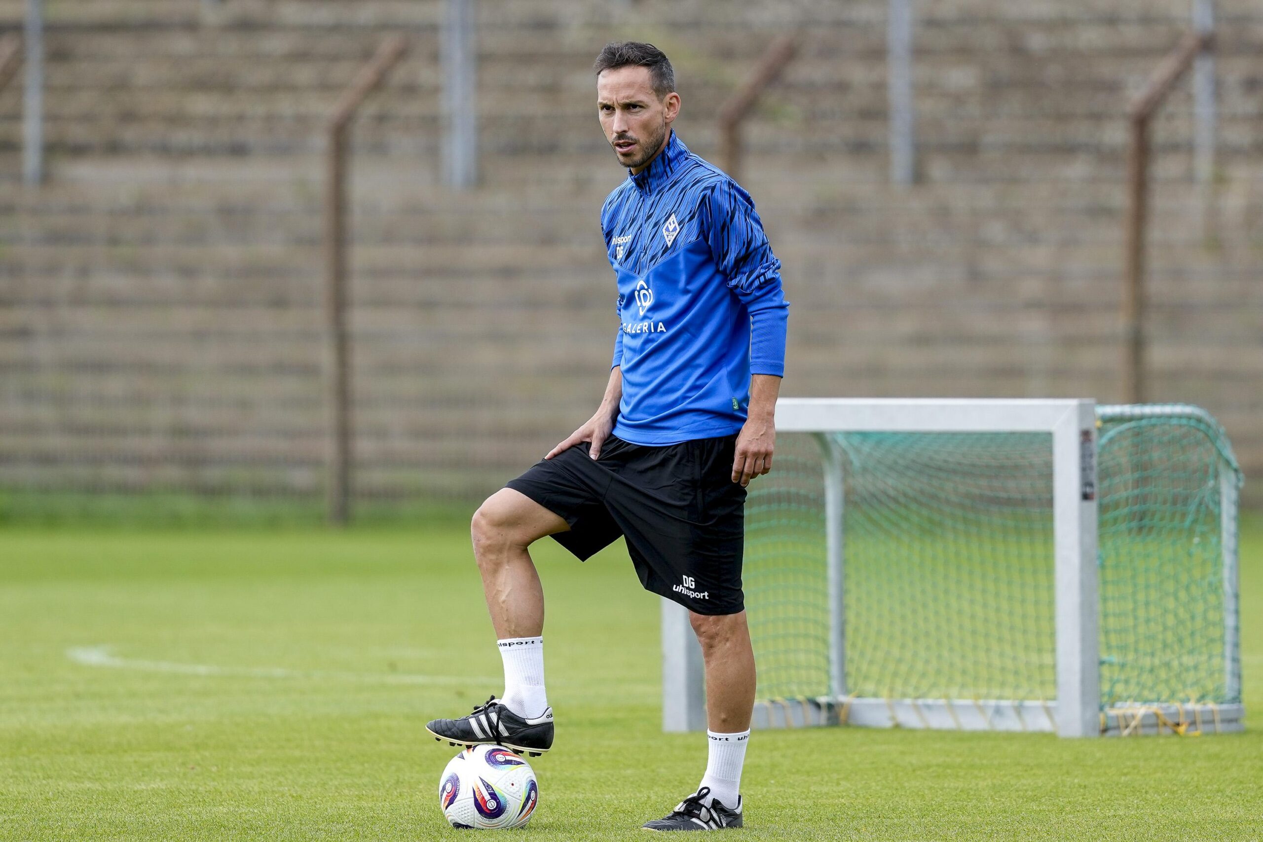Dominik Glawogger stands with one foot on a football at the Waldhof Mannheim training ground.