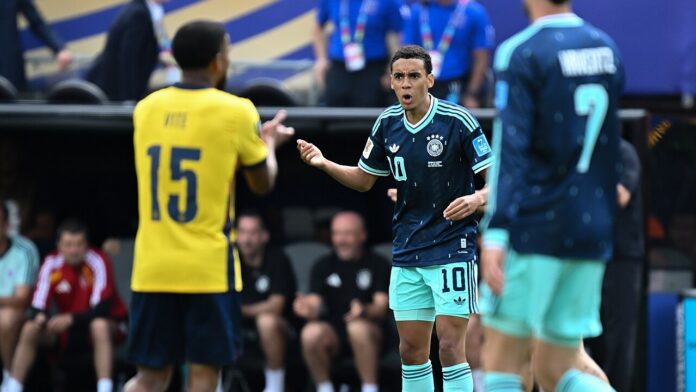 Jamal Musiala gestures on the pitch while wearing Germany’s number 10 shirt.