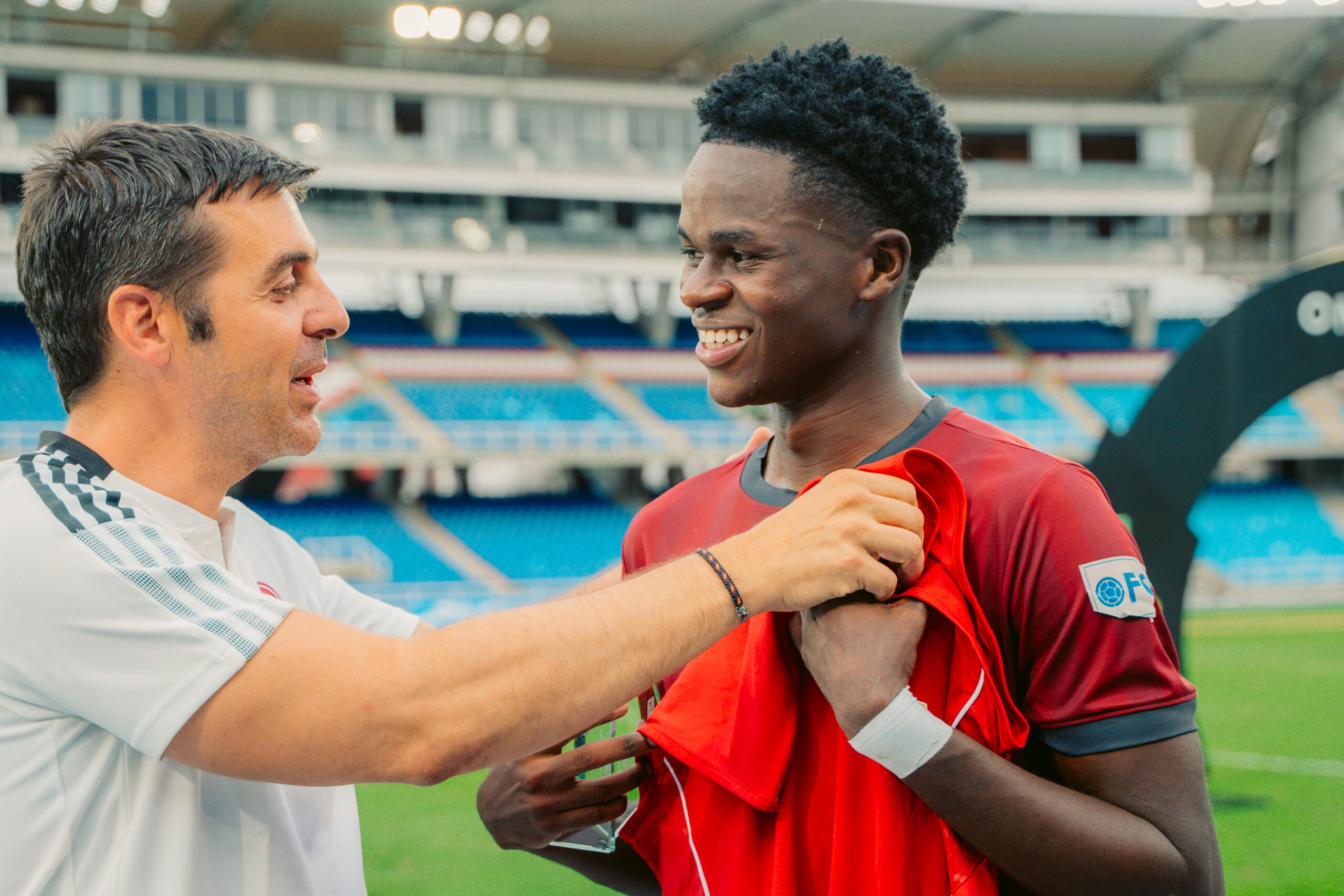 A young footballer receives his shirt during a One-Life Show event at Estadio Pascual Guerrero in Cali.